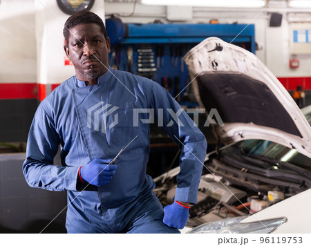 Portrait of african male mechanician posing in workshop 96119753