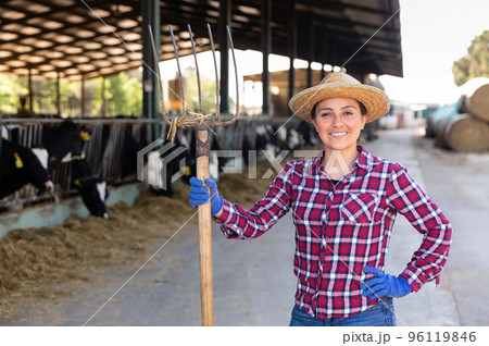 Portrait of a positive woman standing on a livestock farm 96119846