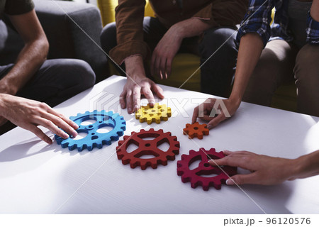 Business team connect pieces of gears. Teamwork, partnership and integration concept Business team connect pieces of gears. Teamwork, partnership and integration concept 96120576