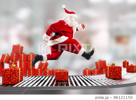 Santa Claus runs on the conveyor belt to arrange deliveries at Christmas time 96121150