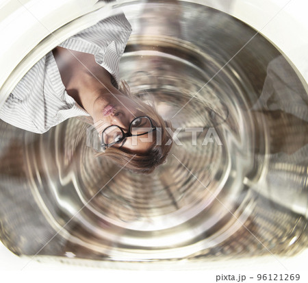 Confused businesswoman has dizziness inside a washing machine. Concept of stress and overwork 96121269