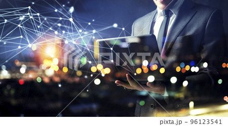 Businessman works with his laptop during the night. double exposure 96123541