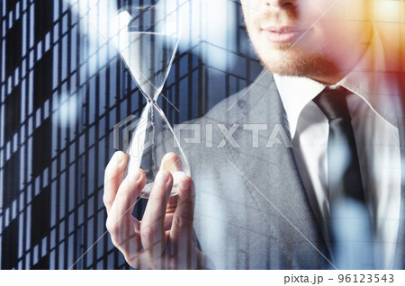 Businessman holding a hourglass. Concept of deadline in business 96123543