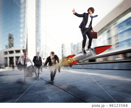 Push to reach the goals before the others. Businessman wins a challenge riding a rocket Push to reach the goals before the others. Businessman wins a challenge riding a rocket 96123568