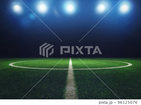 Midfield of grass soccer field at night with headlights Midfield of grass soccer field at night with headlights 96125076