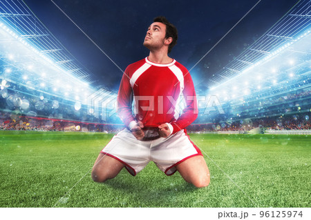 Football player exults in a full stadium 96125974