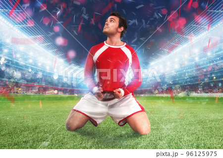 Football player exults in a full stadium 96125975