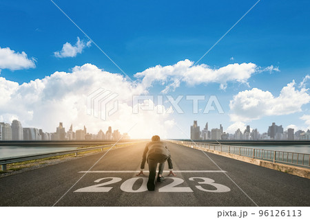 Businessman looking the City skyline with skyscrapers in the background. 2023 year goals concept. Businessman looking the City skyline with skyscrapers in the background. 2023 year goals concept. 96126113