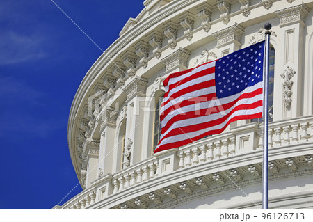 Washington DC Capitol dome detail with waving American flag Washington DC Capitol dome detail with waving American flag 96126713