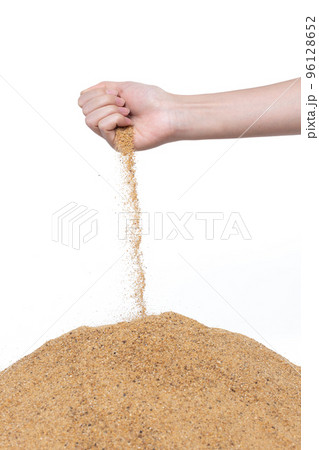 Hand releasing dropping sand. Fine Sand flowing pouring through fingers against white background. Summer beach holiday vacation and time passing concept. Isolated high speed shutter 96128652