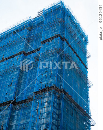 Building under construction wrapped blue protection safety net 96129454