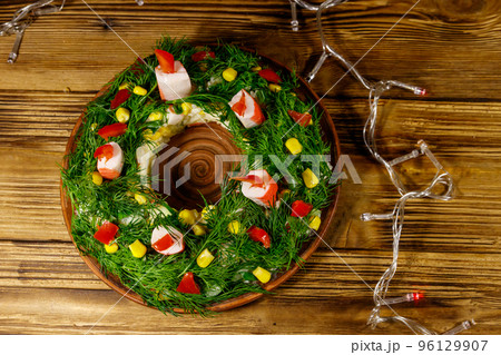 Salad Christmas wreath on a wooden table. Top view Salad Christmas wreath on a wooden table. Top view 96129907