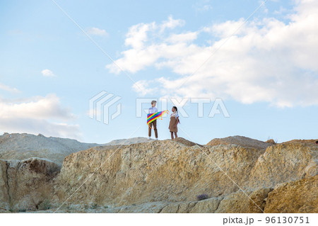 Brother and sister are going to fly a kite chatting sweetly 96130751