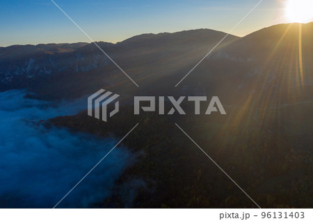 Aerial view of morning fog in the valley in dawn Aerial view of morning fog in the valley in dawn 96131403