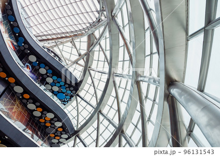 Futuristic Interior. Glass roof with solar panels and levels floors of round Sphere modern building, view from below. Glass roof and walls. Futuristic Interior. Glass roof with solar panels and levels floors of round Sphere modern building, view from below. Glass roof and walls. 96131543