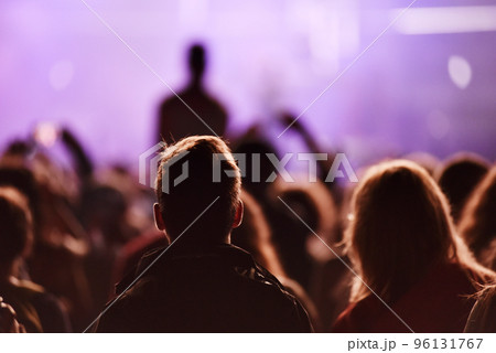 Silhouette of concert crowd in front of bright stage lights Silhouette of concert crowd in front of bright stage lights 96131767