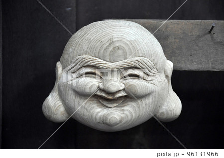 Handmade smiling Buddha wooden statue in Vietnam 96131966