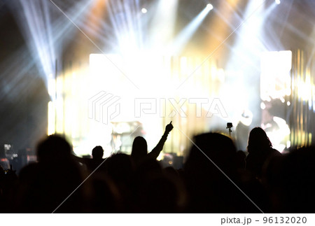Rear view of crowd with arms outstretched at concert Rear view of crowd with arms outstretched at concert 96132020