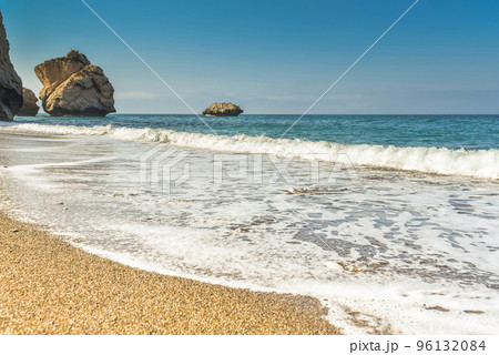 Waves wash over golden sand 96132084