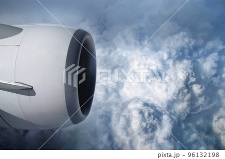 View of the sky and clouds from the airplane porthole. jet engine turbine look through aircraft window 96132198