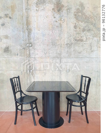 Black wood table and chair set isolated on concrete wall with copy space. Black wood table and chair set isolated on concrete wall with copy space. 96132776