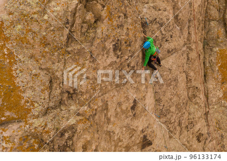 Man Climber Rock Climbing. Cliffs in Tamgaly Tas, Kazakhstan. Aerial View 96133174