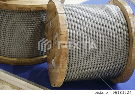 Rope metal steel on a wooden coil. Industrial wire cable Rope metal steel on a wooden coil. Industrial wire cable 96133224