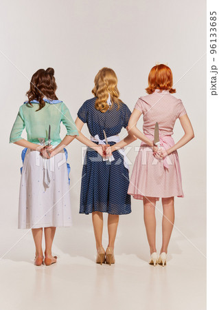 Portrait of three stylish women posing iver grey background. Why women kill remake 96133685
