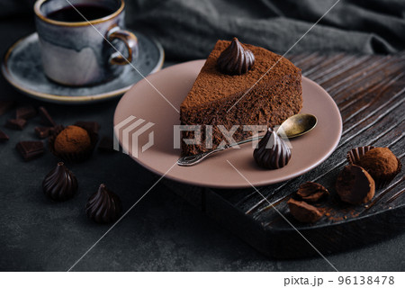 Piece of chocolate cake Truffle and tea cup 96138478