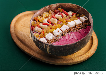 Healthy breakfast raisins and cashew nuts smoothie in coconut bowl Healthy breakfast raisins and cashew nuts smoothie in coconut bowl 96138857