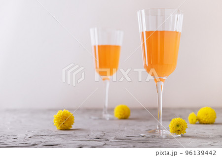 Mimosa alcohol cocktail with orange juice and dry champagne Mimosa alcohol cocktail with orange juice and dry champagne 96139442