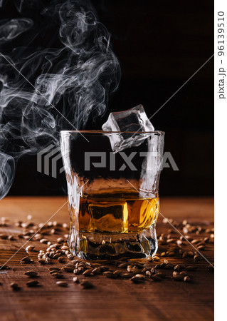 Glass of whiskey with ice and wheat 96139510