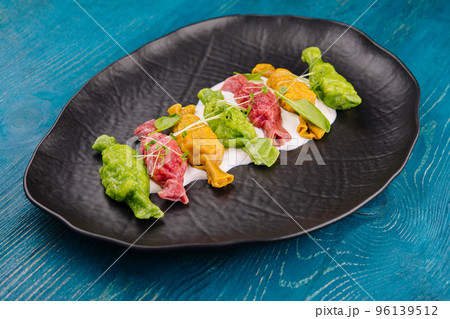 Chinese colourful steamed dumplings on black plate 96139512