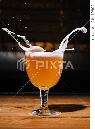 Glass of splashing beer close up 96139902