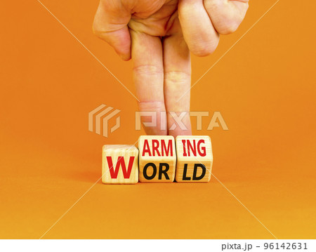 Warming world symbol. Concept words Warming world on wooden cubes. Beautiful orange table orange background. Businessman hand. Business, ecological and warming world concept. Copy space. Warming world symbol. Concept words Warming world on wooden cubes. Beautiful orange table orange background. Businessman hand. Business, ecological and warming world concept. Copy space. 96142631