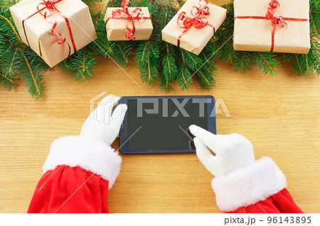Santa Claus's hand in a white glove use gestures for navigation Tablet 96143895