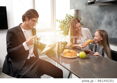 Happy family have a breakfast at home Happy family have a breakfast at home 96144201