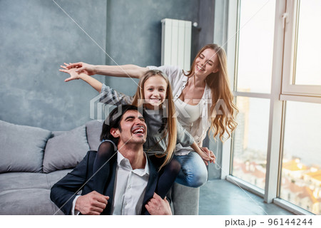Happy little girl play with her mother and father 96144244