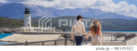 BANNER, LONG FORMAT Couple in love tourists enjoying the views of Architecture and luxury yachts in Lustica Bay, Montenegro. Travel around Montenegro concept. Go Everywhere 96145022