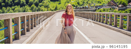 BANNER, LONG FORMAT Montenegro. Woman tourist in background of Dzhurdzhevich Bridge Over The River Tara. Travel around Montenegro concept. Sights of Montenegro Portrait of a disgruntled girl sitting 96145195