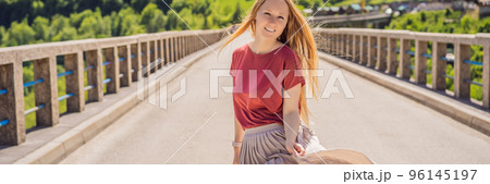 BANNER, LONG FORMAT Montenegro. Woman tourist in background of Dzhurdzhevich Bridge Over The River Tara. Travel around Montenegro concept. Sights of Montenegro Portrait of a disgruntled girl sitting 96145197