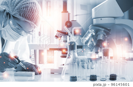 Double exposure microscope and Young woman scientific using equipment in the laboratory for research 96145601