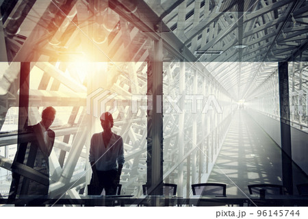 Businessmen that work together in office. Concept of teamwork and partnership. double exposure 96145744