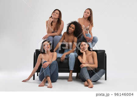Group of women with different body types in jeans and underwear on light background 96146004