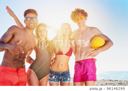 Group of friends playing at beach volley at the beach Group of friends playing at beach volley at the beach 96146299