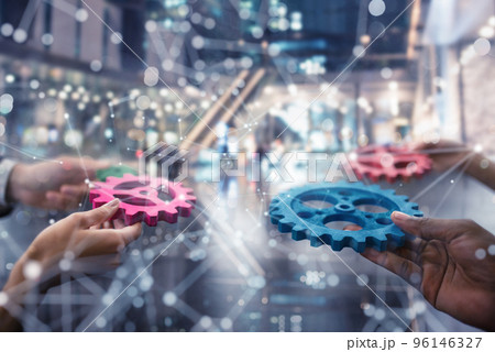 Business team connect pieces of gears. Teamwork, partnership and integration concept. double exposure Business team connect pieces of gears. Teamwork, partnership and integration concept. double exposure 96146327