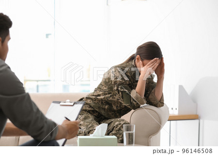 Psychotherapist working with female military officer in office 96146508