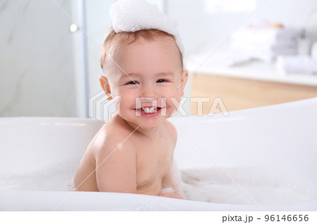 Cute little baby in bathtub at home 96146656