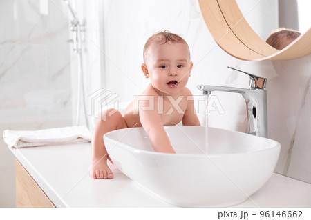Cute little baby playing in bathroom at home 96146662