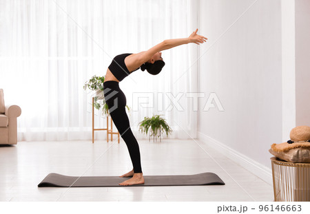 Professional young acrobat practicing yoga at home 96146663